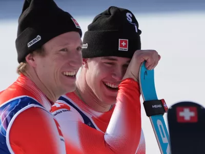 Switzerland's Franjo von Allmen, right, and teammate Switzerland's Nef Tanguy, celebrate winning the gold medal in an alpine ski men's team combined race, at the 2026 Winter Olympics, in Bormio, Italy, Monday, Feb. 9, 2026. (AP Photo/Rebecca Blackwell)