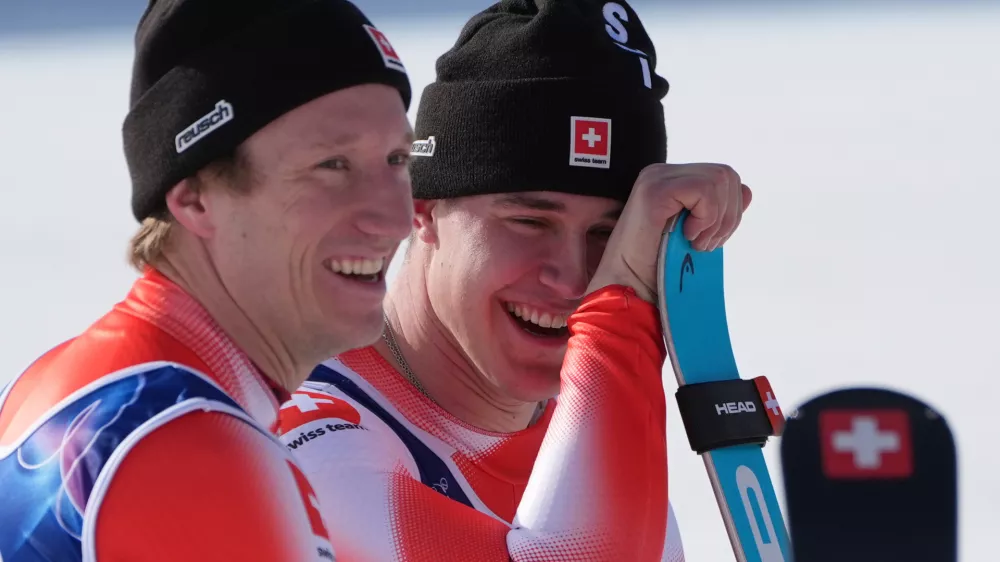 Switzerland's Franjo von Allmen, right, and teammate Switzerland's Nef Tanguy, celebrate winning the gold medal in an alpine ski men's team combined race, at the 2026 Winter Olympics, in Bormio, Italy, Monday, Feb. 9, 2026. (AP Photo/Rebecca Blackwell)