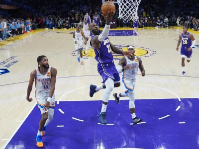 Los Angeles Lakers forward LeBron James (23) puts up a shot as Oklahoma City Thunder guard Isaiah Joe (11) and guard Luguentz Dort (5) watch during the second half of an NBA basketball game Monday, Feb. 9, 2026, in Los Angeles. (AP Photo/Jae C. Hong)