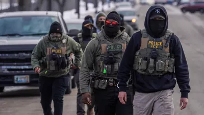 FILE - Federal agents walk down a street while conducting immigration enforcement operations, Thursday, Feb. 5, 2026, in Minneapolis. (AP Photo/Ryan Murphy, File)