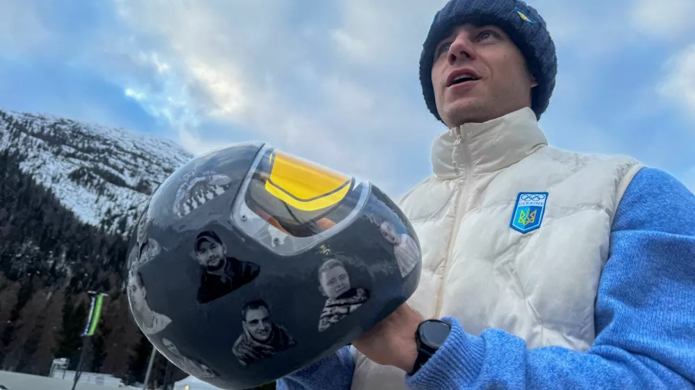 Ukrainian skeleton athlete Vladyslav Heraskevych holds his helmet with images of compatriots killed during the war in Ukraine, at the Milano Cortina Gamesin in Cortina D'Ampezzo, Italy, February 9, 2026. REUTERS/Cristiano Corvino