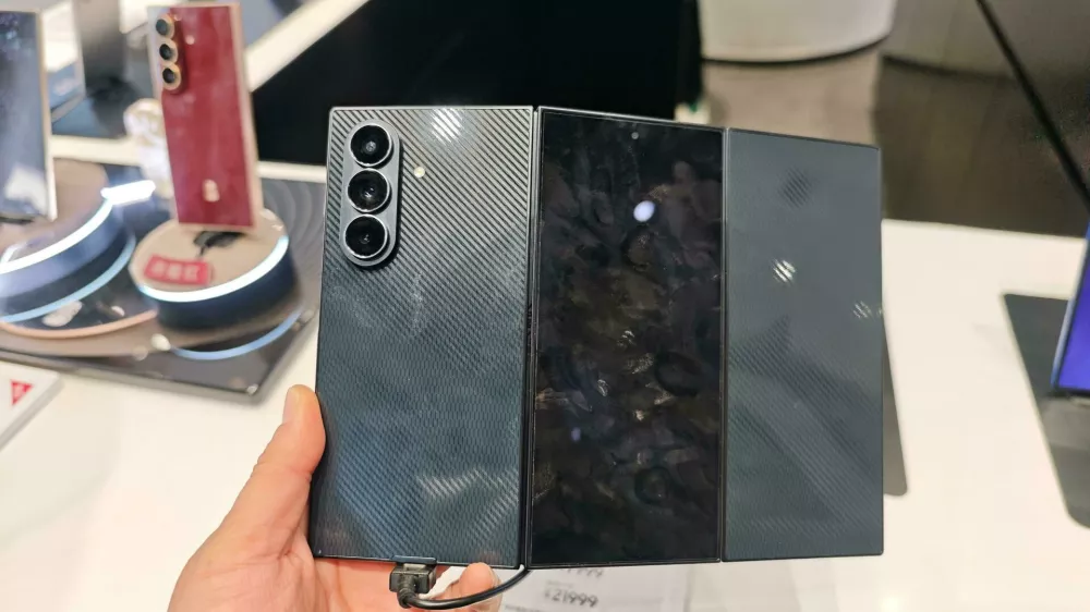 Customers experience the Galaxy Z TriFold smartphone at a flagship store in Shanghai, China, 25 December, 2025.No Use China. No Use France.