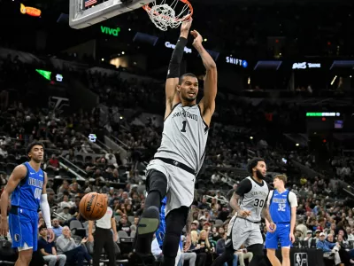 San Antonio Spurs center Victor Wembanyama (1) dunks during the second half of an NBA basketball game against the Dallas Mavericks, Saturday, Feb. 7, 2026, in San Antonio. (AP Photo/Darren Abate)