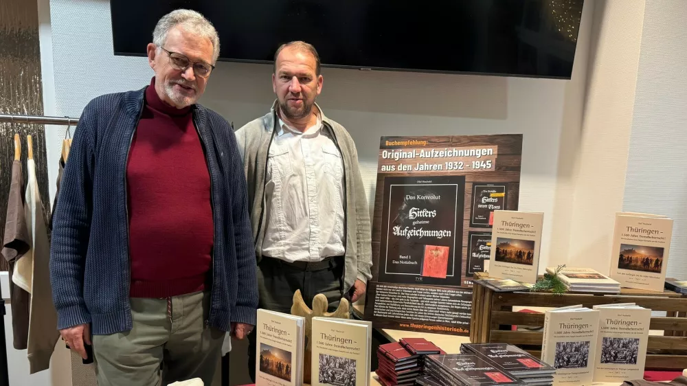 Story from Jam Press (Hitler Notebook Sold)Pictured: Author Olaf Haubold (L) with Thomas Buchzik, the publisher of TYR Verlag in Arnstadt.'G&ouml;ring ate like a pig!' 'Hitler's notebook' sells for Ł26k after being found in atticA diary believed to have been written by Adolf Hitler has been found in an attic and sold for around Ł26,000.It has 113 handwritten pages with references to high-ranking Nazi official Hermann G&ouml;ring and German Hollywood star Marlene Dietrich.In the notebook, Hitler allegedly declared his love for the German actress.This book offers lots of material for speculation, but it has yet to be authenticated as being written by the Nazi leader.An expert at least confirmed that the paper dates from the period.The notebook was first offered to author Olaf Haubold, 74, who was unable to match the seller's asking price.He then brokered a deal with a collector he knew, who ended up paying a reported fee of around Ł26,000 (&euro;30,000).Olaf, who lives in Thuringia, told What's The Jam: "In 2008, an elderly gentleman came to my office and offered me documents from Adolf Hitler's estate."It seemed suspicious to me at first, but I asked him to show me a sample."He then came with a notebook and several documents that initially appeared to be authentic."Because I lack expertise in this area, I sought help from historians, and we concluded that there was a possibility of its authenticity."But the asking price was too high for me, given the uncertainties."At the time, I knew a wealthy collector who had also sponsored some of my projects."He was prepared to pay the asking price for the entire collection."I don't know the exact fee, the price mentioned in reports is an estimate."The seller said he found the notebook in an attic, but Olaf wasn't convinced that part was true.He said: "The gentleman who offered the collection didn't want to say anything about its origin."The 'attic find' explanation was too vague for us."Some documents bear stamps of the Ministry for State Security of the former GDR, otherwise known as the Stasi."It's possible it came from somewhere like that."After brokering the sale, Olaf secured the rights to use the collection for his 2025 book 'The Collection &ndash; Hitler's Secret Records'.He was granted permission to analyse the material with East German writer Martin Stade before his death in 2018.The buyer has also passed away since procuring the notebook, and it is now owned by his children.Olaf said: "I only have the publication rights from the collector and now from his heirs."The collection is still complete and has not yet been offered publicly at auction or in any other way."The notebook is old; whether it contains Hitler's handwriting is unproven."Despite the uncertainties, I decided to publish the material."The esteemed reader may form their own opinion."In his own opinion, Olaf said it's "very likely" the work was produced by Hitler's hand.In the first pages, Hitler is quoted as criticising the Reich Chancellery before moving in."The building is in a state of complete decay. Ceiling and floor are rotten. Wallpaper and flooring are decayed."The highlight was a bath in the bathroom. Should I bathe in everyone's sewage? Never!"After a birthday party, he is said to have written the following about his deputy: "G&ouml;ring ate like a pig again."And about Marlene Dietrich, he said: "I have to try to bring her back to Germany."I've had all of Dietrich's new films sent to me."I think I've fallen in love with her."Eva doesn't stand a chance against Dietrich."But I won't let on. The woman has to come to Germany, even if it's by force. I'll set the intelligence service on her."Dietrich is hanging around with the Americans now. I'll write her another letter."The best thing would be to offer her money. Women will do anything for money, you can see that with Eva."I'll use Eva as a test subject and study her behaviour."I'm going to make Dietrich a money offer and see if she takes the bait."So, let's get to work. Because I am the F&uuml;hrer."The secret service says it won't be so easy to get hold of Dietrich."What is easy anyway! I told them to put in the effort. I want to see results."That's what they're paid for, and not badly at that."It's not the first time a journal has been attributed to Adolf Hitler.In 1983, the German magazine Stern bought the 'Hitler Diaries', a series of 60 volumes of journals allegedly written by the Nazi leader.But they were later found to have been forged and two men were convicted of defrauding Stern of 9.3 million Deutsche Marks, about Ł2.3 million.The case provided the basis for the 1992 film Schtonk!'ENDS,Image: 1067280549, License: Rights-managed, Restrictions:, Model Release: no