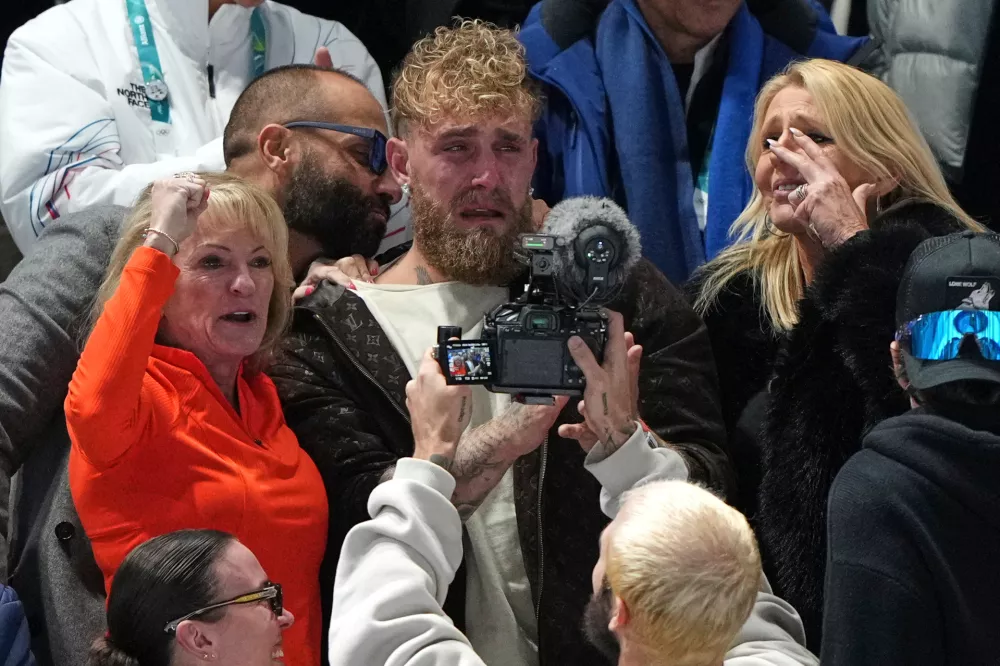 Jake Paul of the U.S., center, cries after his fianc&eacute; Jutta Leerdam of the Netherlands won the gold medal in the women's 1,000 meters speedskating race at the 2026 Winter Olympics, in Milan, Italy, Monday, Feb. 9, 2026. (AP Photo/Antonio Calanni)