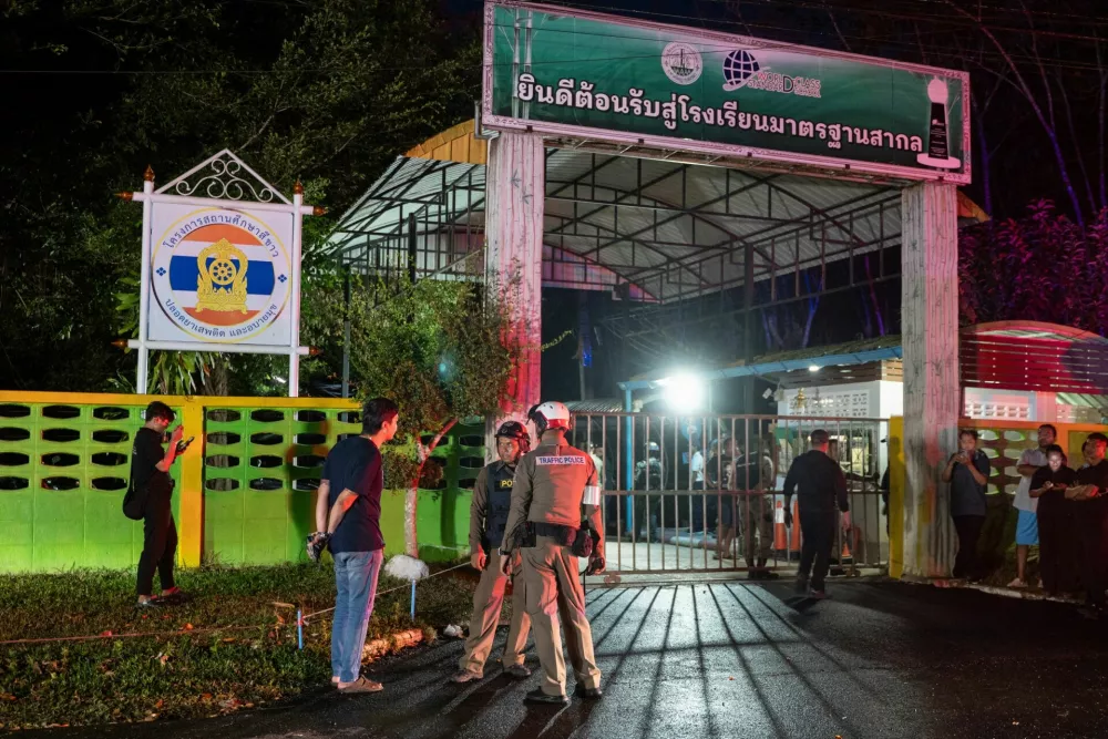 Police officers and people stand near the gate of Patongprathankiriwat School, following and incident in which a gunman entered the school and held an unknown number of students and teachers hostage, in southern Thailand's Songkhla, Thailand, February 11, 2026. REUTERS/Hannares Haripai