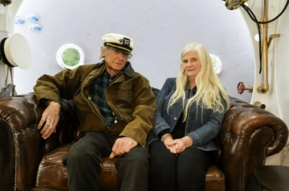 Keith and Jenny Lovelock. // A couple have built a Beatles-themed Yellow Submarine Airbnb - and even John Lennon's family have come to stay. Keith Lovelock and his wife Jen built the submarine - and turned it into one of the quirkiest holiday stays 's in the world. The whole rental is dotted with references to nautical travel and the Beatles -and even comes with a John Lennon-inspired mannequin. The accommodation in Marton, Manawatu-Wanganui, New Zealand is deemed by Airbnb as one of the quirkiest places to stay. Photo released 11/01/2026,Image: 1065229162, License: Rights-managed, Restrictions: Editorial use, commercial use may require additional licenses. We don't use AI to make images which could be mistaken for news photos. AI use will be clearly indicated. Supplied on condition you ensure personal data is processed in compliance with UK GDPR, Model Release: no