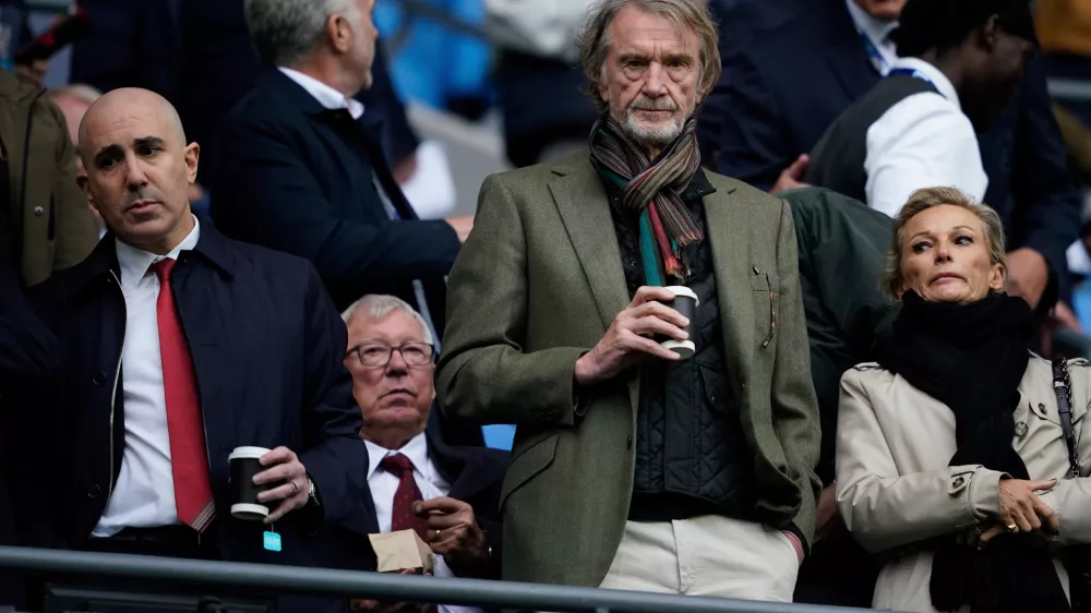 FILE - Manchester United co-owner Jim Ratcliffe stands in front of the former manager Alex Ferguson during the Premier League soccer match between Manchester City and Manchester United in Manchester, England, on Sept. 14, 2025. (AP Photo/Dave Thompson, File)