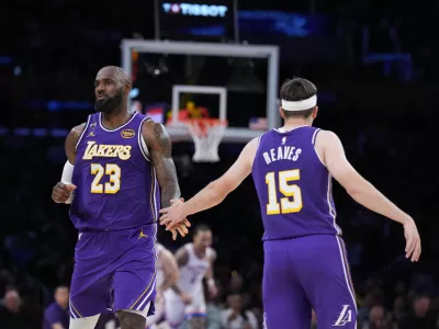 Los Angeles Lakers forward LeBron James (23) and guard Austin Reaves (15) celebrate a basket during the second half of an NBA basketball game against the Oklahoma City Thunder Monday, Feb. 9, 2026, in Los Angeles. (AP Photo/Jae C. Hong)