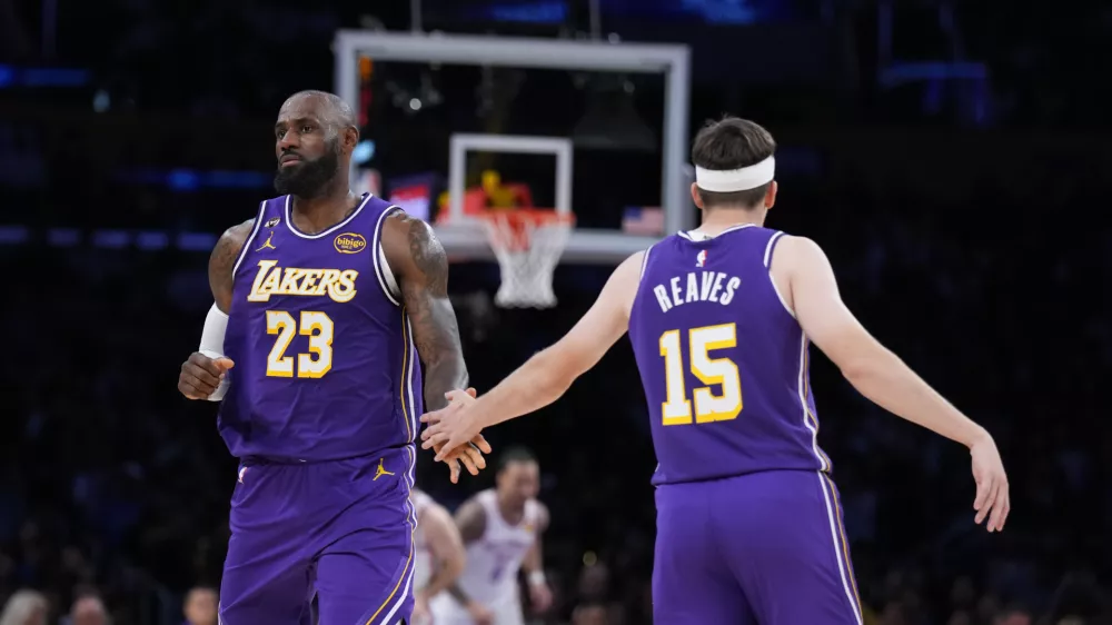 Los Angeles Lakers forward LeBron James (23) and guard Austin Reaves (15) celebrate a basket during the second half of an NBA basketball game against the Oklahoma City Thunder Monday, Feb. 9, 2026, in Los Angeles. (AP Photo/Jae C. Hong)