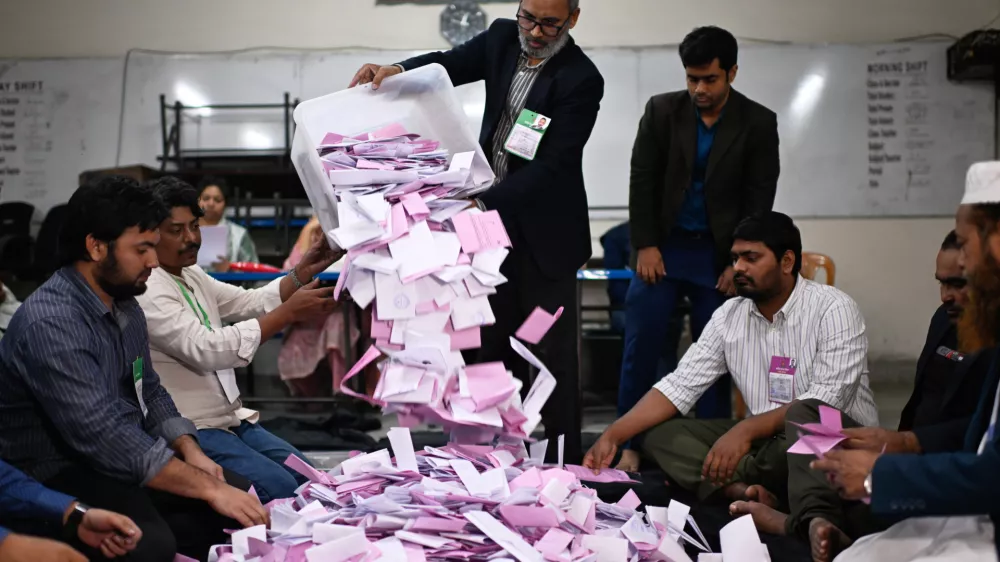 Polling officials begin the counting of votes cast for the national parliamentary election in Dhaka, Bangladesh, Thursday, Feb. 12, 2026. (AP Photo/Mahmud Hossain Opu)