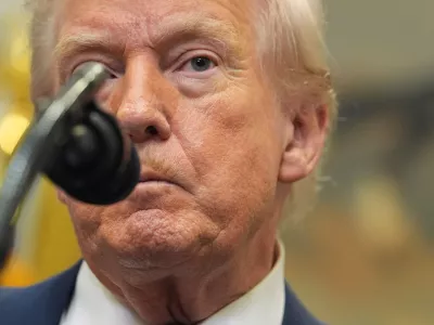 President Donald Trump listens to a question from a reporter during an event with Environmental Protection Agency director Lee Zeldin to announce the EPA will no longer regulate greenhouse gases, in the Roosevelt Room of the White House, Thursday, Feb. 12, 2026, in Washington. (AP Photo/Evan Vucci)