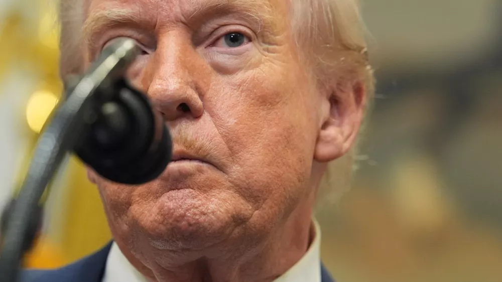 President Donald Trump listens to a question from a reporter during an event with Environmental Protection Agency director Lee Zeldin to announce the EPA will no longer regulate greenhouse gases, in the Roosevelt Room of the White House, Thursday, Feb. 12, 2026, in Washington. (AP Photo/Evan Vucci)