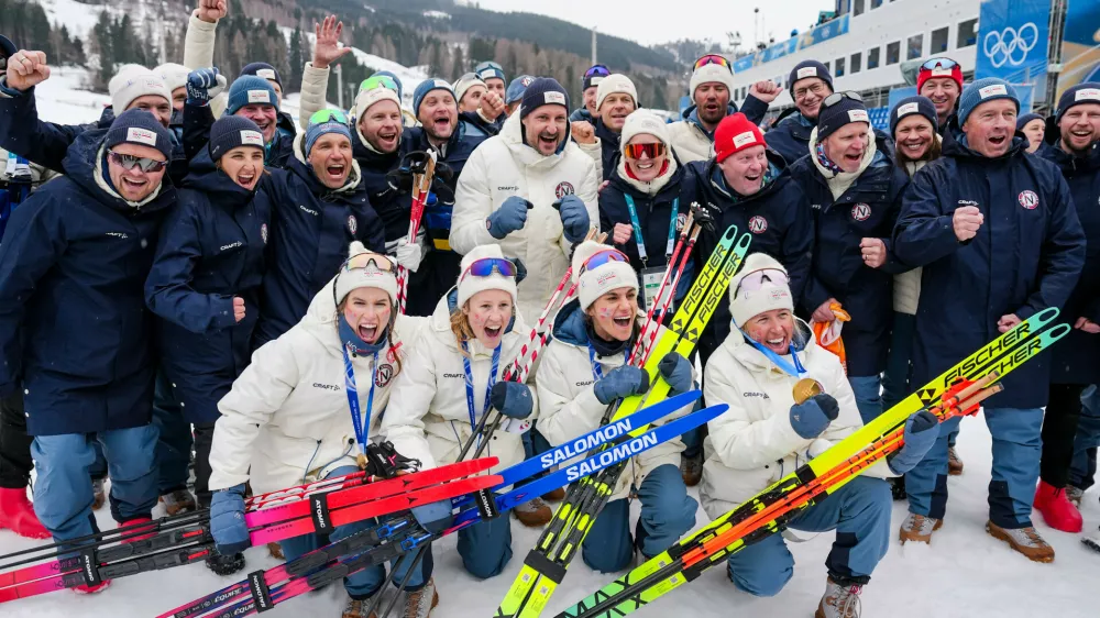 Heidi Weng, Karoline Simpson-Larsen, Astrid Oeyre Slind, and Kristin Austgulen Fosnaes, of Norway, pose with their team after winning the gold medal in the cross country skiing women's 4 x 7.5km relay at the 2026 Winter Olympics, in Tesero, Italy, Saturday, Feb. 14, 2026. (AP Photo/Matthias Schrader)