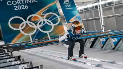 Domen Prevc, of Slovenia, goes down the ramp during his trial jump of the ski jumping men's large hill individual at the 2026 Winter Olympics, in Predazzo, Italy, Saturday, Feb. 14, 2026. (AP Photo/Evgeniy Maloletka)