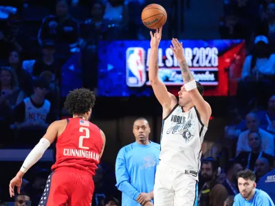 World forward Luka Dončić, of Slovenia, shoots over USA Stars guard Cade Cunningham (2) during the NBA All-Star basketball game Sunday, Feb. 15, 2026, in Inglewood, Calif. (AP Photo/Mark J. Terrill)