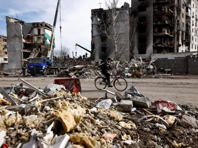 A man rides a bicycle past buildings that were destroyed by Russian shelling, amid Russia's Invasion of Ukraine, in Borodyanka, Kyiv region, Ukraine April 7, 2022. REUTERS/Zohra Bensemra