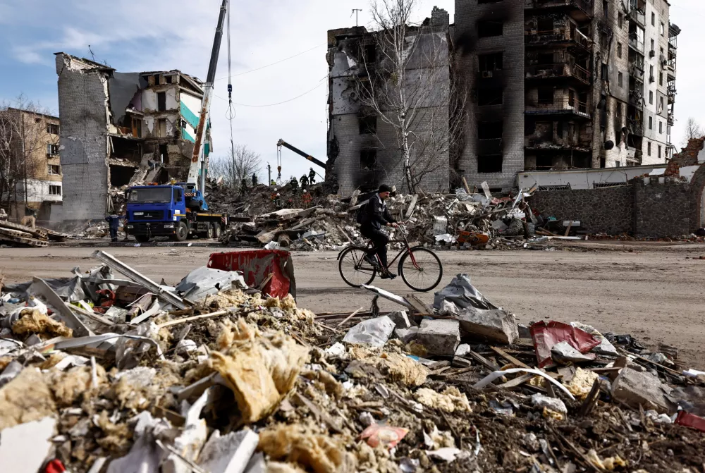 A man rides a bicycle past buildings that were destroyed by Russian shelling, amid Russia's Invasion of Ukraine, in Borodyanka, Kyiv region, Ukraine April 7, 2022. REUTERS/Zohra Bensemra