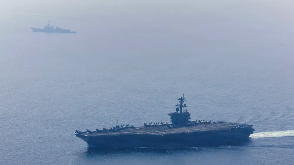 The U.S. Navy's Nimitz-class aircraft carrier USS Abraham Lincoln and Arleigh Burke-class guided-missile destroyer USS Frank E. Petersen Jr. sail during a photo exercise in the Arabian Sea, February 6, 2026. U.S. Navy/Mass Communication Specialist 1st Class Jesse Monford/Handout via REUTERS THIS IMAGE HAS BEEN SUPPLIED BY A THIRD PARTY