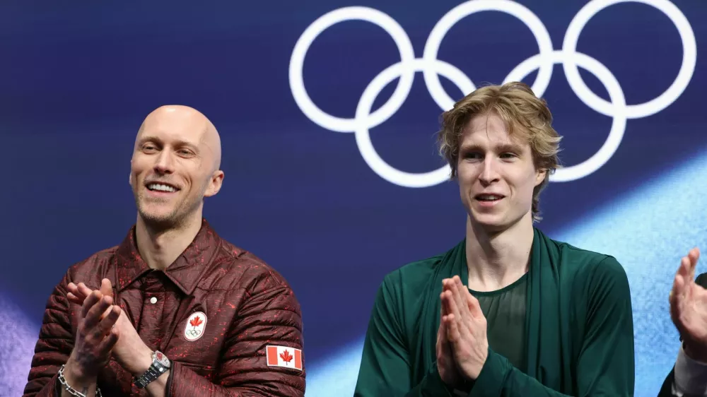 Milano Cortina 2026 Olympics - Figure Skating - Men Single Skating - Free Skating - Milano Ice Skating Arena, Milan, Italy - February 13, 2026. Stephen Gogolev of Canada with his coach Benoit Richaud after his performance during the Free Skating REUTERS/Yara Nardi