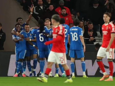 Real Madrid's Vinicius Junior celebrates with team mates the opening goal during a Champions League playoff soccer match between SL Benfica and Real Madrid in Lisbon, Portugal, Tuesday, Feb. 17, 2026. (AP Photo/Pedro Rocha)