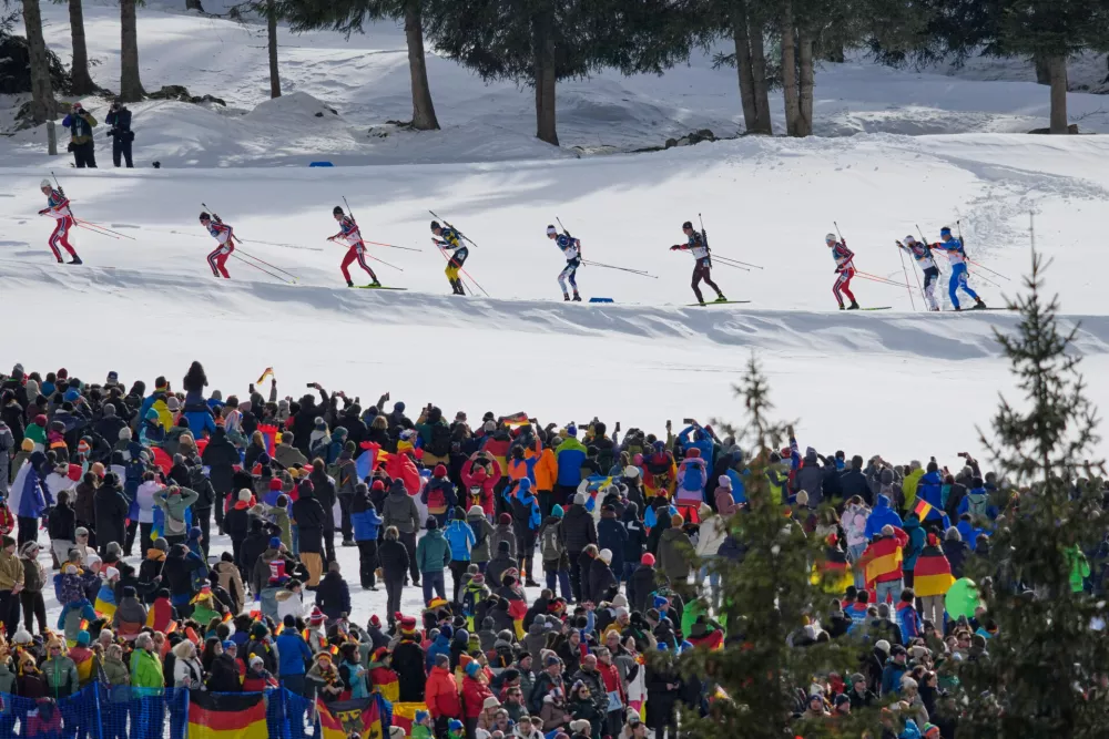 Athletes compete during the men's biathlon 15-kilometers mass start race at the 2026 Winter Olympics, in Anterselva, Italy, Friday, Feb. 20, 2026. (AP Photo/David J. Phillip)