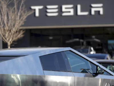 A Tesla Cybertruck and other Telsla vehicles sit at a dealership, Wednesday, March 19, 2025, in Kennesaw, Ga. (AP Photo/Mike Stewart)