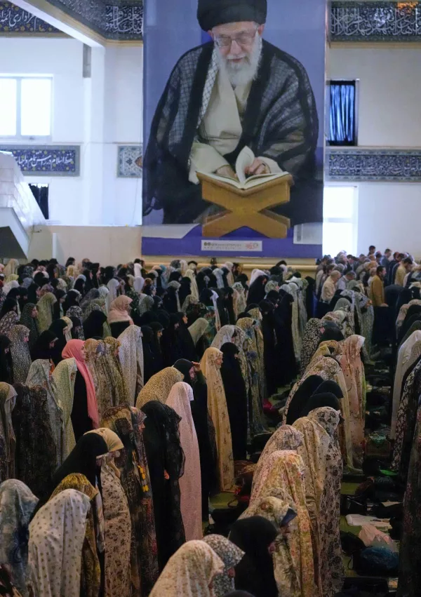 Worshippers perform the Friday prayers under a portrait of the Supreme Leader Ayatollah Ali Khamenei at the Imam Khomeini Grand Mosque in Tehran, Iran, Friday, Feb. 27, 2026. (AP Photo/Vahid Salemi)