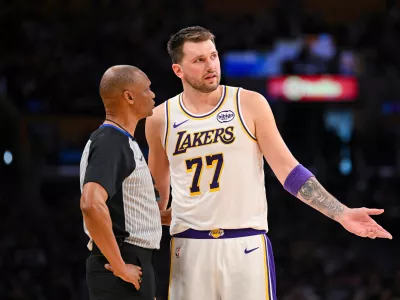 Los Angeles Lakers guard Luka Doncic speaks to referee Michael Smith during the first half of an NBA basketball game against the Boston Celtics, Sunday, Feb. 22, 2026, in Los Angeles. (AP Photo/Katie Chin)