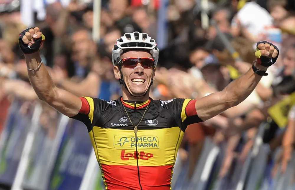 Omega Pharma-Lotto's Philippe Gilbert of Belgium raises his arms as he crosses the finish line to win the Clasica San Sebastian cycle race in San Sebastian July 30, 2011. REUTERS/Vincent West (SPAIN - Tags: SPORT CYCLING)