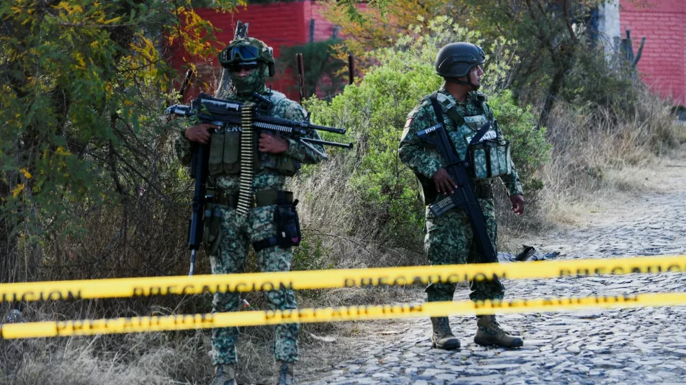 Soldiers stand at a cordoned‑off area where federal forces carried out an operation to capture cartel boss Nemesio Oseguera, 'El Mencho,' who died in a helicopter after being injured during a Mexican special‑forces raid in a wooded area outside the town Tapalpa, Mexico, February 23, 2026. REUTERS/Liberto Urena