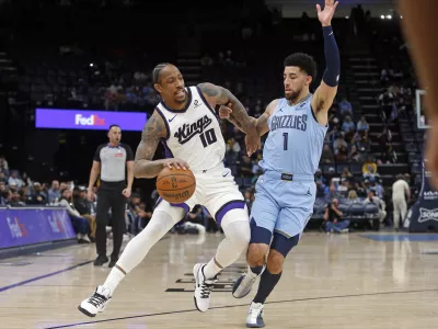Feb 23, 2026; Memphis, Tennessee, USA; Sacramento Kings guard DeMar DeRozan (10) drives to the basket as Memphis Grizzlies guard Scotty Pippen Jr. (1) defends during the first quarter at FedExForum. Mandatory Credit: Petre Thomas-Imagn Images