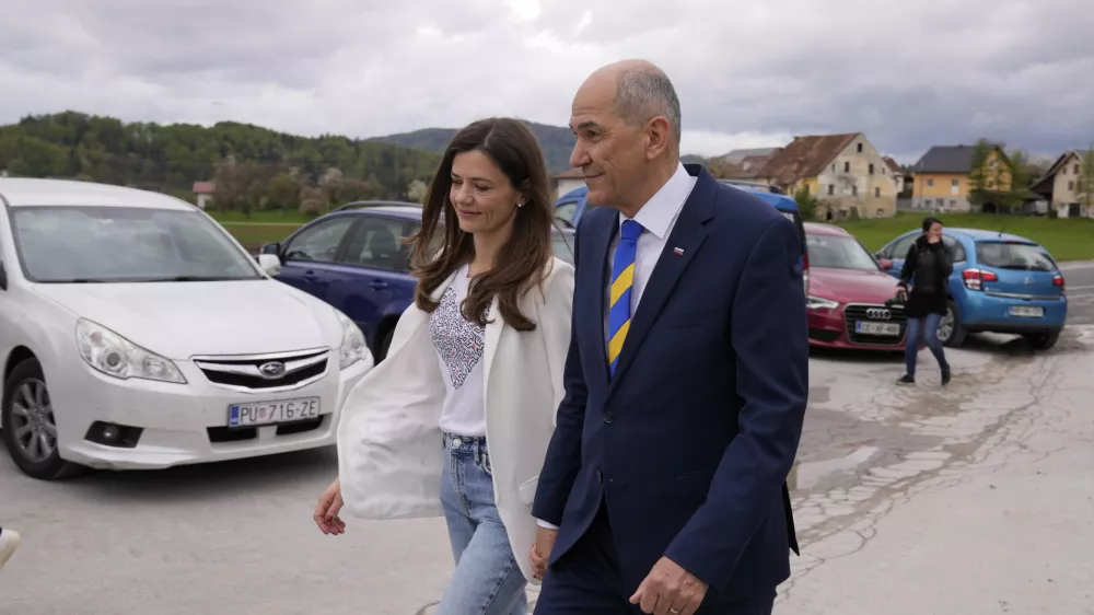 Slovenia's Prime Minister Janez Jansa with his wife Urska Bacovnik Jansa walks away from a polling station in Sentilj, Slovenia, Sunday, April 24, 2022. Slovenians cast ballots in a parliamentary election that is expected to be a tight race between Prime Minister Janez Jansa's ruling right-wing populists and liberals in the politically divided European Union nation. (AP Photo/Darko Bandic)