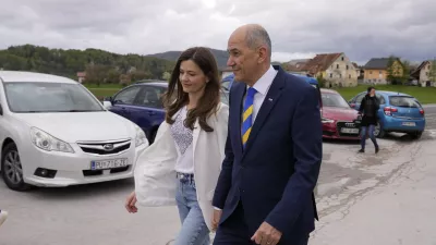 Slovenia's Prime Minister Janez Jansa with his wife Urska Bacovnik Jansa walks away from a polling station in Sentilj, Slovenia, Sunday, April 24, 2022. Slovenians cast ballots in a parliamentary election that is expected to be a tight race between Prime Minister Janez Jansa's ruling right-wing populists and liberals in the politically divided European Union nation. (AP Photo/Darko Bandic)