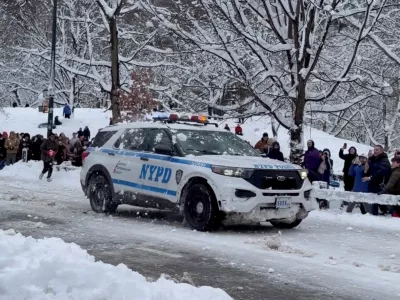 People throw snowballs at an NYPD vehicle in Central Park, as New Yorkers venture outside during a powerful winter storm that blanketed much of the U.S. Northeast, in New York, U.S., February 23, 2026, in this still image obtained from social media video. Maira Ahmad/via REUTERS THIS IMAGE HAS BEEN SUPPLIED BY A THIRD PARTY. MANDATORY CREDIT. NO RESALES. NO ARCHIVES. VERIFICATION: - Location and date verified from original file metadata