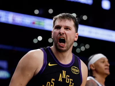 Los Angeles Lakers guard Luka Doncic (77) reacts after scoring during the second half of an NBA basketball game against the Orlando Magic, Tuesday, Feb. 24, 2026, in Los Angeles. (AP Photo/Caroline Brehman)