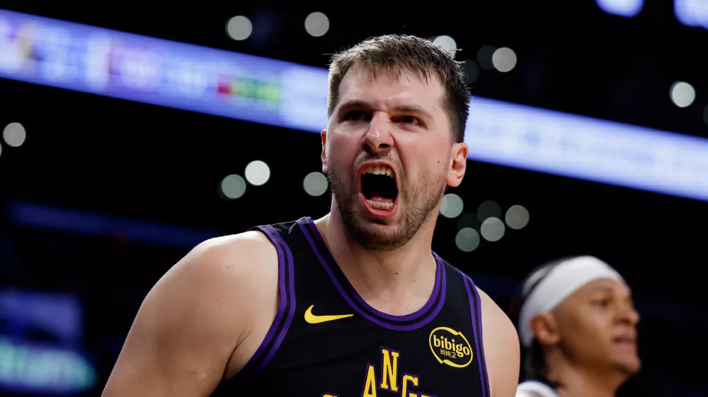 Los Angeles Lakers guard Luka Doncic (77) reacts after scoring during the second half of an NBA basketball game against the Orlando Magic, Tuesday, Feb. 24, 2026, in Los Angeles. (AP Photo/Caroline Brehman)