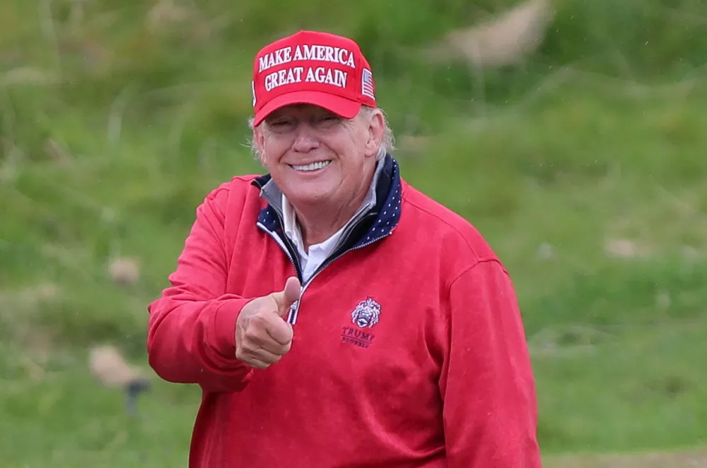 FILE PHOTO: Former U.S. President and Republican presidential candidate Donald Trump gestures as he plays golf at Trump International Golf Links course, in Doonbeg, Ireland May 4, 2023. REUTERS/Damien Storan/File Photo
