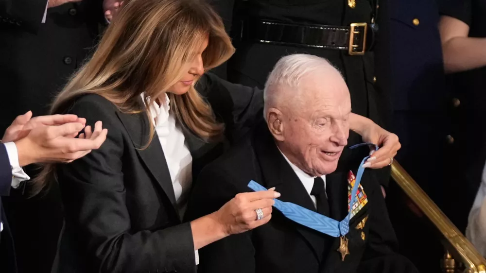 First lady Melania Trump awards World War II Navy pilot Capt. Royce Williams the Congressional Medal of Honor as President Donald Trump delivers the State of the Union address to a joint session of Congress in the House chamber at the U.S. Capitol in Washington, Tuesday, Feb. 24, 2026. (AP Photo/Mark Schiefelbein)