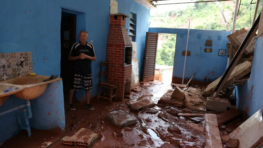 Jose Florencio Torres, 69, stands next to debris of his damaged house, following heavy rains that killed residents and left missing people, in Juiz de Fora, Minas Gerais state, Brazil, February 25, 2026. REUTERS/Pilar Olivares