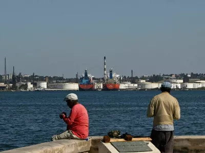 Men fish in Havana Bay across from the Nico Lopez oil refinery, as the U.S. Treasury Department said it would authorize companies seeking licenses to resell Venezuelan oil to Cuba, in Havana, Cuba February 25, 2026. REUTERS/Norlys Perez