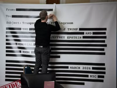 An "Epstein Reading Room" studio backdrop, of a redacted email, is set-up for guest photos during a rebuttal to President Donald Trump's State of the Union hosted by Defiance.org, the Portland Frog Brigade, and COURIER, at the National Press Club, in Washington, Tuesday, Feb. 24, 2026. (AP Photo/Cliff Owen)