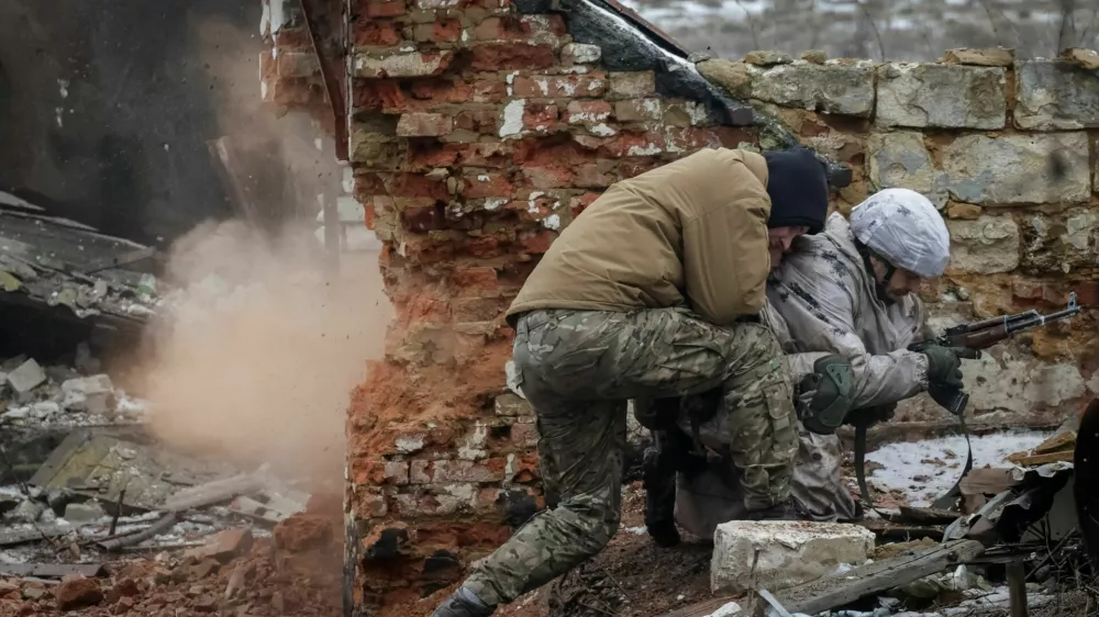An Instructor pushes a recruit of the 28th Separate Mechanized Brigade of the Armed Forces of Ukraine during a grenade explosion during a military exercise before combat missions, amid Russia's attack on Ukraine, in Kharkiv region, Ukraine February 26, 2026. REUTERS/Sofiia Gatilova
