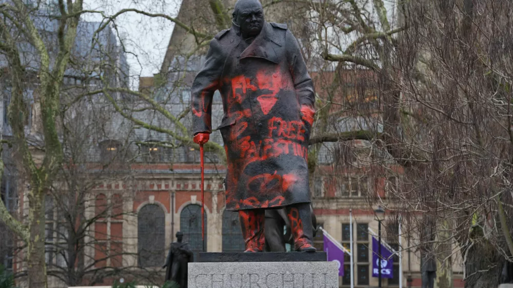 The statue of Winston Churchill in Parliament Square, which has been defaced with graffiti branding the former prime minister a "Zionist war criminal", in London, Friday Feb. 27, 2026. (Lucy North/PA via AP)