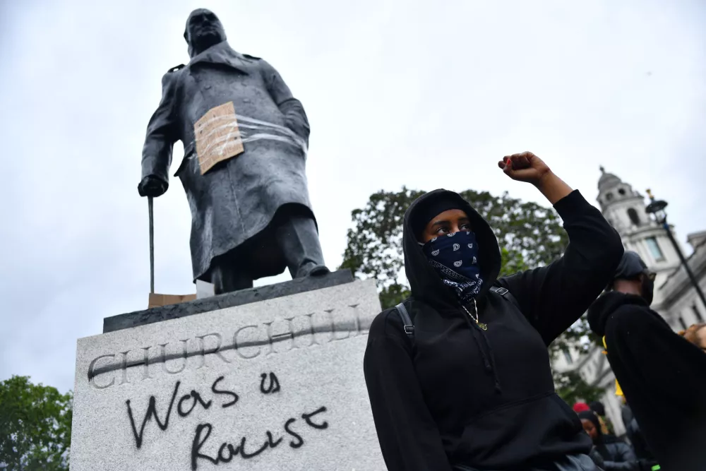 A demonstrator reacts infront of graffiti on a statue of Winston Churchill in Parliament Square during a Black Lives Matter protest in London, following the death of George Floyd who died in police custody in Minneapolis, London, Britain, June 7, 2020. REUTERS/Dylan Martinez