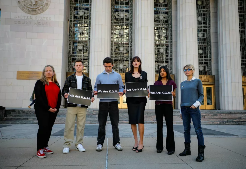Supporters of plaintiff Kaley G.M. hold signs as they stand outside the courthouse on the day Kaley G.M. takes the stand at a trial in a key test case accusing Meta and Google's YouTube of harming children's mental health through addictive social media platforms, in Los Angeles, California, U.S., February 25, 2026. REUTERS/Mike Blake