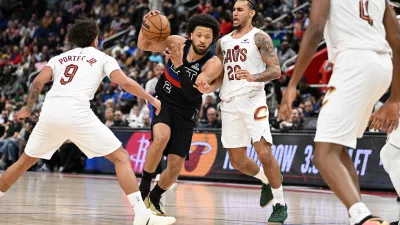 Feb 27, 2026; Detroit, Michigan, USA; Detroit Pistons guard Cade Cunningham (2) tries to drive between Cleveland Cavaliers guard Craig Porter Jr. (9) and Cleveland Cavaliers guard Jaylon Tyson (20) in the first half at Little Caesars Arena. Mandatory Credit: Lon Horwedel-Imagn Images
