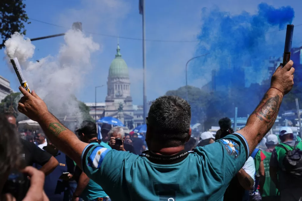 Demonstrators rally outside Congress as they protest against a labor reform bill proposed by President Javier Milei's government in Buenos Aires, Argentina, Friday, Feb. 27, 2026. (AP Photo/Rodrigo Abd)