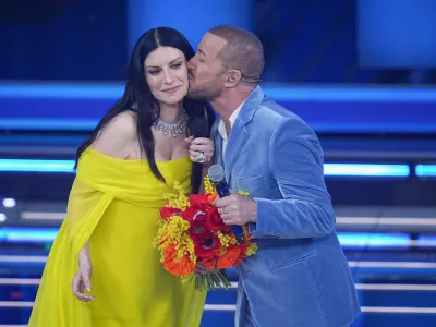 Raf and Laura Pausini onstage during the 76th edition of the Sanremo Italian Song Festival at the Ariston Theatre, in Sanremo, Italy, Thursday, Feb. 26, 2026. (Marco Alpozzi/LaPresse via AP)