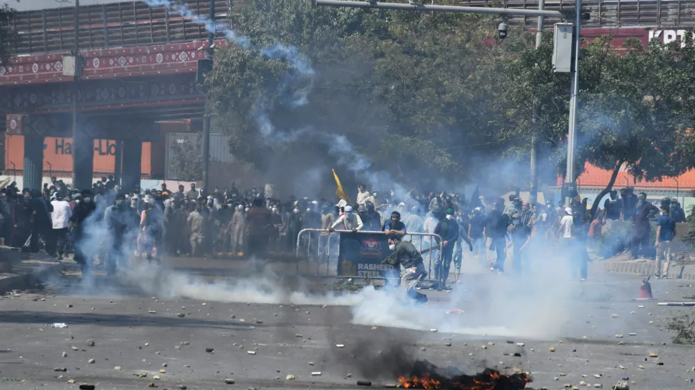 Shiite Muslims hurl back a tear gas shell fired by police to disperse them during a protest to condemn the killing of Iranian Supreme Leader Ayatollah Ali Khamenei, in Karachi, Pakistan, Sunday, March 1, 2026. (AP Photo/Ali Raza)